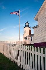 Flag in Front of Pemaquid Point Light in Maine